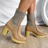 The Melanie Knit Boot is a mid-calf boot featuring a knit upper, a rubber lug sole, a 1" platform, and a 3" heel. 