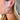 Close view of model wearing the What About Me Hoop Earrings that feature latch-back gold hoops wrapped with brown faux-leather material.