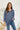 Frontal view of the On Your Mark Top that features a blue silky material, a collared neckline, a button-up front, and a long cuffed sleeve.