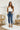 Frontal view of the Flying Monkey: Ease Mom Jeans that features a dark wash denim, a front button and zip closure, two front pockets, a cuffed bottom hem, two back pockets, and a mom jean fit.