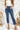 Frontal view of the Flying Monkey: Ease Mom Jeans that features a dark wash denim, a front button and zip closure, two front pockets, a cuffed bottom hem, two back pockets, and a mom jean fit.