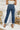 Back view of the Flying Monkey: Ease Mom Jeans that features a dark wash denim, a front button and zip closure, two front pockets, a cuffed bottom hem, two back pockets, and a mom jean fit.