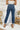 Back view of the Flying Monkey: Ease Mom Jeans that features a dark wash denim, a front button and zip closure, two front pockets, a cuffed bottom hem, two back pockets, and a mom jean fit.