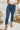 Frontal view of the Flying Monkey: Ease Mom Jeans that features a dark wash denim, a front button and zip closure, two front pockets, a cuffed bottom hem, two back pockets, and a mom jean fit.