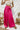Frontal view of the High Standards Pants that features a pink silk material, a high rise fit, a thick elastic waist band, a pleated design, and a wide leg fit.