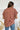 Back view of the Golden Days Top that features a brick material, a collared neckline, a short cuffed sleeve, a button-up front, a front pocket, and a flowy fit.