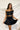 Frontal view of the Make It Mine Skort that features a black silk material, a high-rise fit, an elastic waist band, a flowy ruffle bottom, a shorts lining, and a back zipper closure.