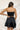 Back view of the Make It Mine Skort that features a black silk material, a high-rise fit, an elastic waist band, a flowy ruffle bottom, a shorts lining, and a back zipper closure.