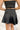 Back view of the Make It Mine Skort that features a black silk material, a high-rise fit, an elastic waist band, a flowy ruffle bottom, a shorts lining, and a back zipper closure.