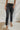 
Frontal view of the Flying Monkey: Amie Straight Leg Jeans that features a faded black wash denim, a high-rise fit, a four button closure, two front pockets, a distressed ankle hem, two back pockets, and a straight leg fit.
