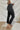 
Side view of the Flying Monkey: Amie Straight Leg Jeans that features a faded black wash denim, a high-rise fit, a four button closure, two front pockets, a distressed ankle hem, two back pockets, and a straight leg fit.
