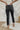 
Back view of the Flying Monkey: Amie Straight Leg Jeans that features a faded black wash denim, a high-rise fit, a four button closure, two front pockets, a distressed ankle hem, two back pockets, and a straight leg fit.
