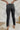 
Back view of the Flying Monkey: Amie Straight Leg Jeans that features a faded black wash denim, a high-rise fit, a four button closure, two front pockets, a distressed ankle hem, two back pockets, and a straight leg fit.
