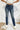 Frontal view of the Rooted Denim: Elodie Bootcut Jeans that features a dark wash denim, a front button and zipper closure, two front pockets, two back pockets, and a bootcut fit.
