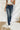 Frontal view of the Rooted Denim: Elodie Bootcut Jeans that features a dark wash denim, a front button and zipper closure, two front pockets, two back pockets, and a bootcut fit.