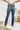 Back view of the Rooted Denim: Elodie Bootcut Jeans that features a dark wash denim, a front button and zipper closure, two front pockets, two back pockets, and a bootcut fit.