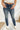 Frontal view of the Rooted Denim: Elodie Bootcut Jeans that features a dark wash denim, a front button and zipper closure, two front pockets, two back pockets, and a bootcut fit.