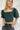 Frontal view of the Turn Back Time Top that features a green corduroy material, a straight neckline, a half puffy sleeve, a smocked back, and a cropped fit.