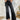 Frontal view of the Rooted Denim: Crue Flare Jeans that features a faded black wash denim, a front two button and zip closure, two front pockets, a frayed bottom hem, two back pockets, and a flare fit.