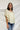 Frontal view of the Soul Searching Top that features an ivory material, a multi-colored floral print, a scoop neckline, a short flowy sleeve with a ruffle hem, and a flowy fit.