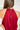 Back view of the Unwritten Tank Top that features a red material, a halter neck, a sleeveless design, a pointed front and back, and a flowy fit.