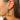 Side view of model wearing the Dream On Earrings in Multi which features medium, closed hoop covered with teal, fuchsia, light pink, orange and marigold beads.