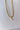 Close up view of the Special Moment Necklace which features double gold layer necklace, chain link and roping details.