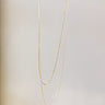 Front view of the Better Than The Rest Necklace which features a dainty gold, double chain.