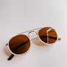 Front view of the I-Sea: All Aboard Sunglasses in Pearl which features pearl tortoise circle frames, gold details and brown frames.