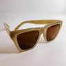 Front view of the I-Sea: Ava Sunglasses in Oatmeal & Brown which features light taupe frames with brown lenses.