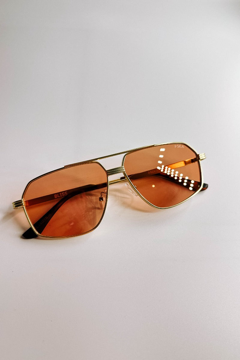 Front view of the I-Sea: Bliss Sunglasses in Gold & Amber features aviator shaped gold frames with amber lenses.