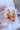 The Sweet Escape Earring is an acrylic dangle style earring featuring a three chain link design with one link a matte orange and the other two a clear orange ombre.