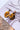 The Talk The Talk Earring is a dangle style earring featuring a tortoiseshell design with a multi-colored stud.