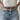Front view of model wearing the Western Dreams Chain Belt which features thick gold chain with gold braided details and a gold buckle for closure.