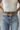 Front view of model wearing the Western Dreams Chain Belt which features thick gold chain with gold braided details and a gold buckle for closure.
