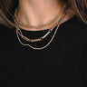 Front view of model wearing the Delilah Gold Chain Link Layer Necklace which features one gold roped layer, one gold chain layer and one gold rectangle chain layer.