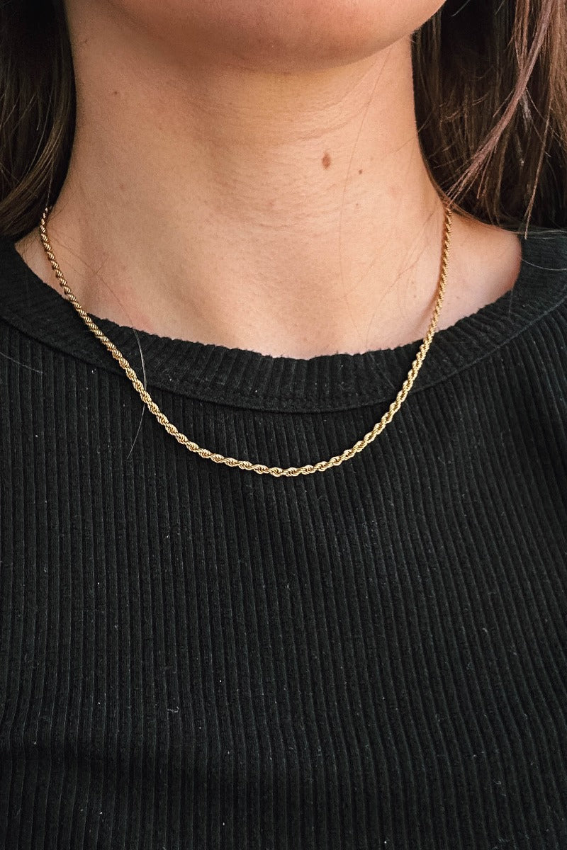 Front view of model wearing the Thea Gold Rope Necklace which features single gold roped laye with adjustable clasp closure.