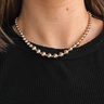 Front view of model wearing the Noelle Gold Beads Necklace which features one layer of gold beads and adjustable clasp closure.