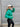 Side view of model wearing the Call It Even Puffer Jacket features green puffer fabric, two front pockets, a high neckline, a silver zip up, and long sleeves