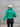 Back view of model wearing the Call It Even Puffer Jacket features green puffer fabric, two front pockets, a high neckline, a silver zip up, and long sleeves