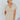 Frontal view of the Runaway Summer Romper that features a V neckline, a short cuffed sleeve, a ruched front, a cinched waist band, and a cuffed bottom hem.