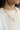Front view of model wearing the Isla Amber Stone Gold Chain Layer Necklace which features one flat gold band layer, one gold chain layer and one gold roped layer with amber stone medallion.