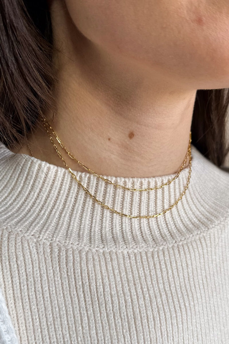 Front view of model wearing the Everly Gold Chain Layer Necklace which features two layered mini gold chain links.