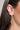 Side view of model wearing the Miley Gold Hammered Skinny Scoop Hoop which features open, gold, hammered scooped skinny hoops.