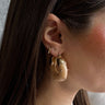 Front view of model wearing the Willow Nude & Gold Hoop which features natural medium hoops with gold details.