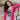 Front close up view of model wearing the You Are Fabulous Cardigan which features hot pink knit fabric with a long-line hem, front pockets, and long balloon sleeves with ribbed cuffs.