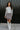 Full body view of model wearing the Sitting Pretty Skirt which features a cream and brown geometric pattern fabric with frayed trim, a zipper on the side, and a lining.