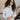 Front view of model wearing the Liana Mock Neck Top in Ivory, that features ivory ribbed fabric, high neckline, cropped waist and ribbed long sleeves.