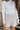 Front view of model wearing the Liana Mock Neck Top in Ivory, that features ivory ribbed fabric, high neckline, cropped waist and ribbed long sleeves.