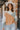 Front view of model wearing the Going West Sweater, that features ivory, peach, and light blue color blocking, a high round neckline, and long balloon sleeves with ribbed cuffs